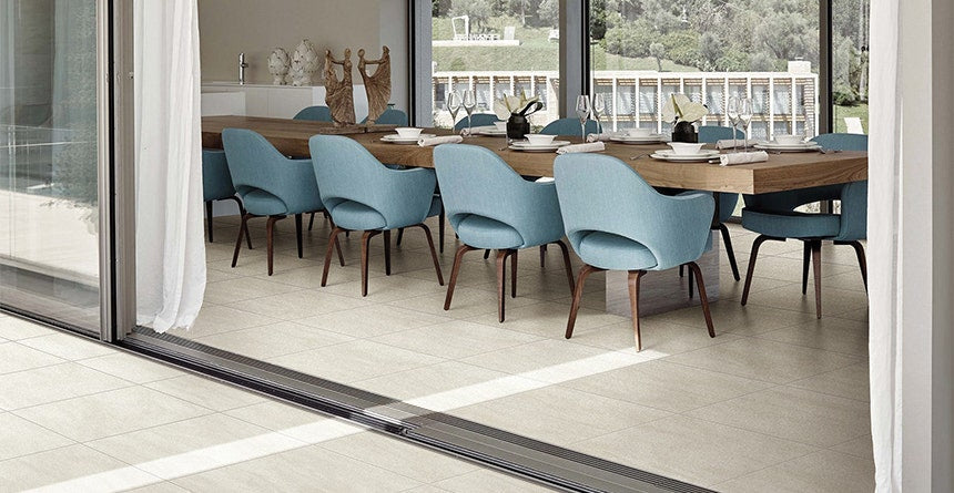 Indoor and outdoor tiled dining area with a seamless transition