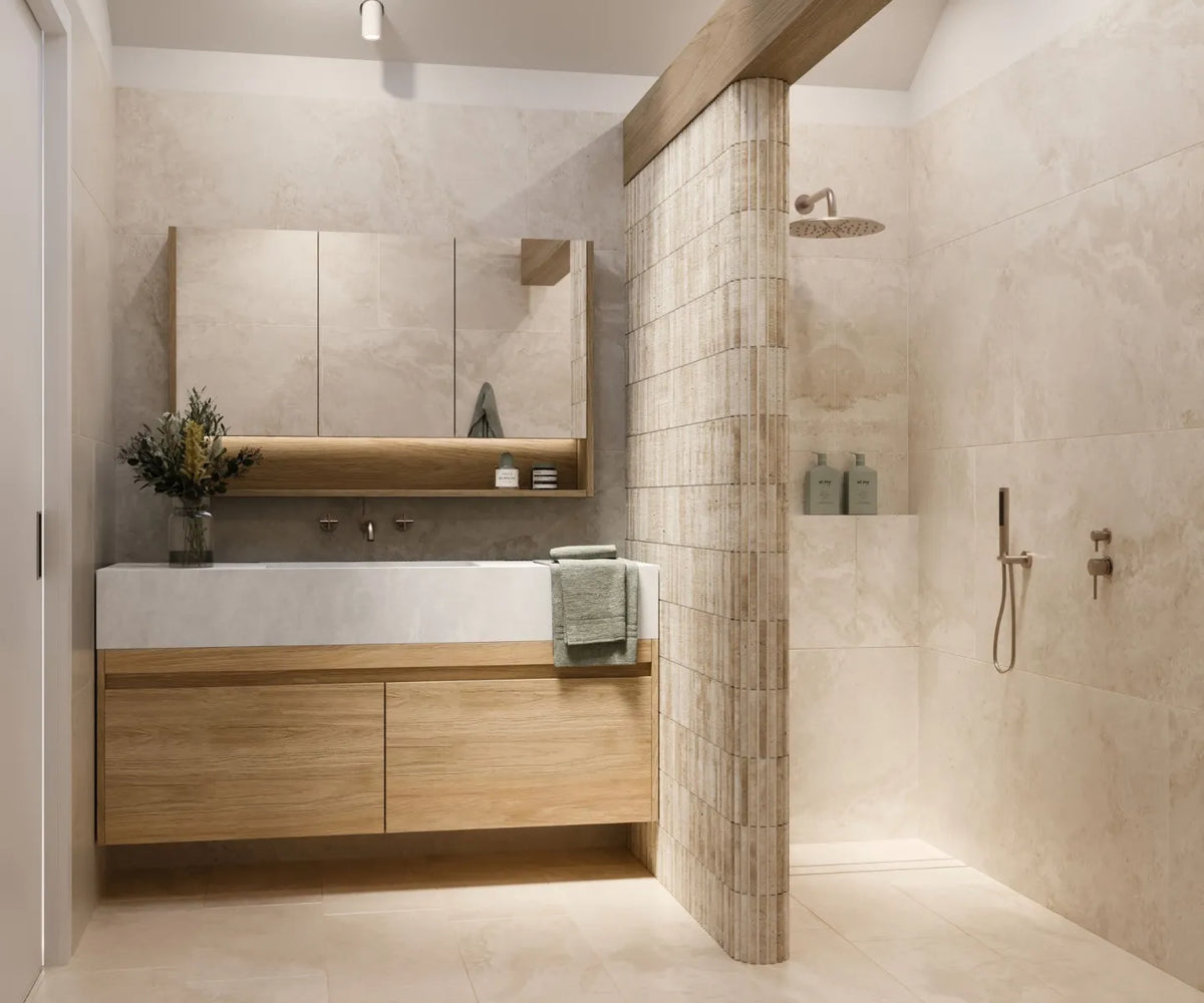 Contemporary bathroom featuring a floating timber vanity, integrated basin, curved tiled shower screen and large-format stone-look tiles in warm neutral tones.