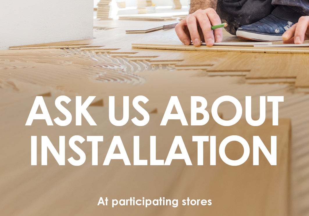 Timber-look flooring installation service banner featuring a flooring installer laying wood-look planks.