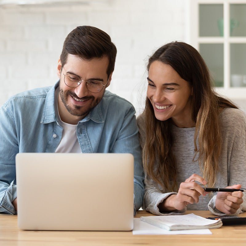 Couple researching home renovation ideas online, using a laptop to explore tile, flooring and design inspiration options.