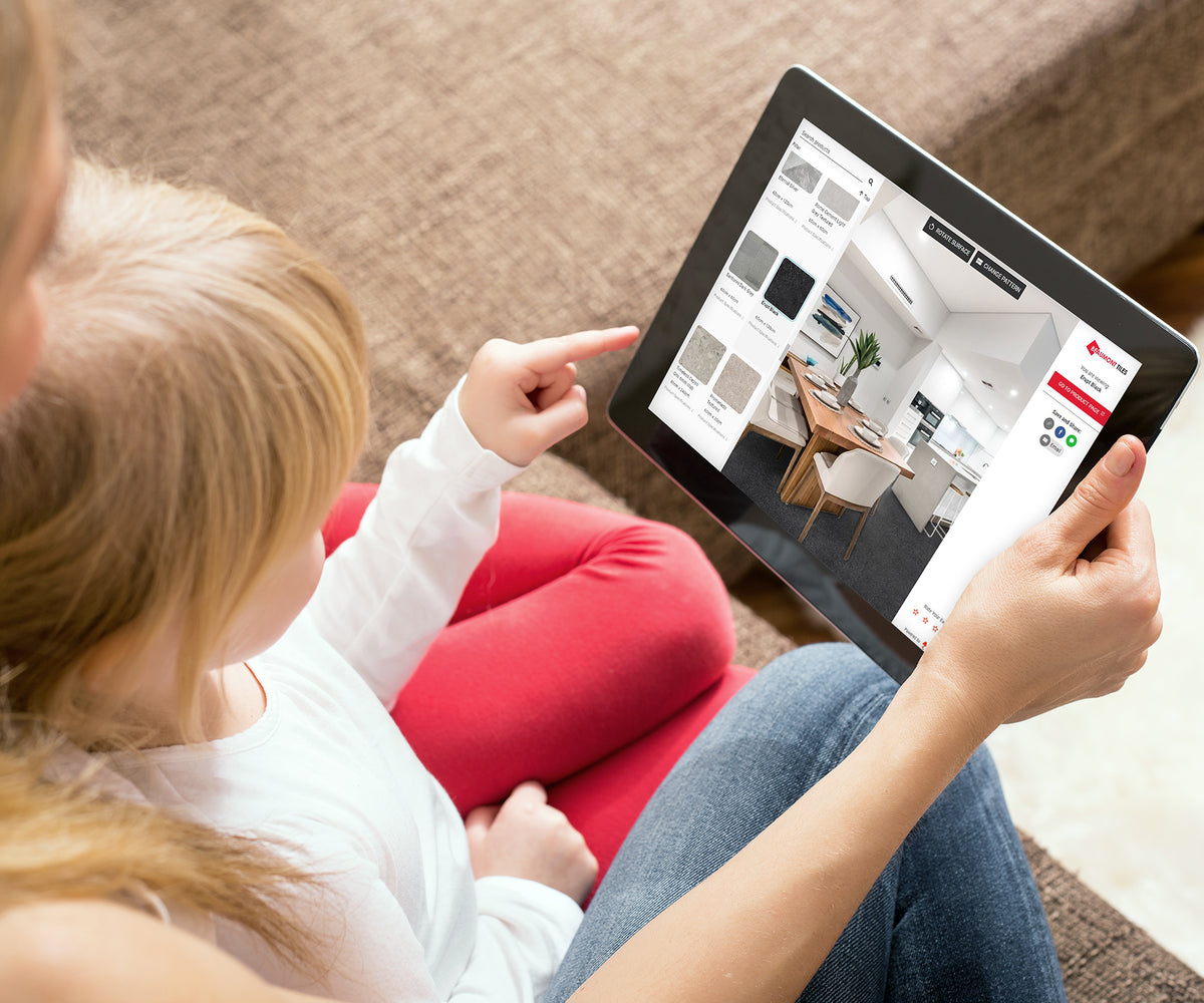 Person using Beaumont Tiles’ BeVisual Live room visualiser on a tablet to preview flooring and tile selections in a virtual kitchen before making a purchase.