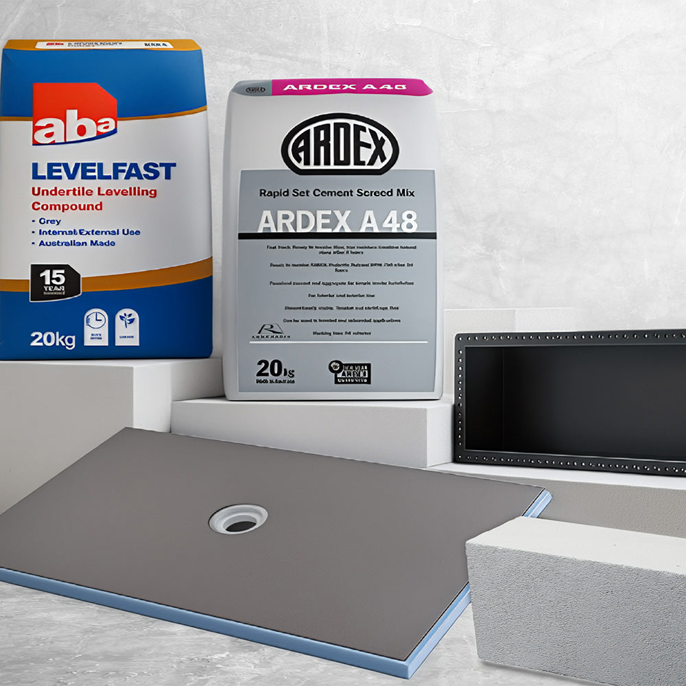 Bathroom tiling materials including floor levelling compound, screed mix, shower base and linear drain for tile installation.