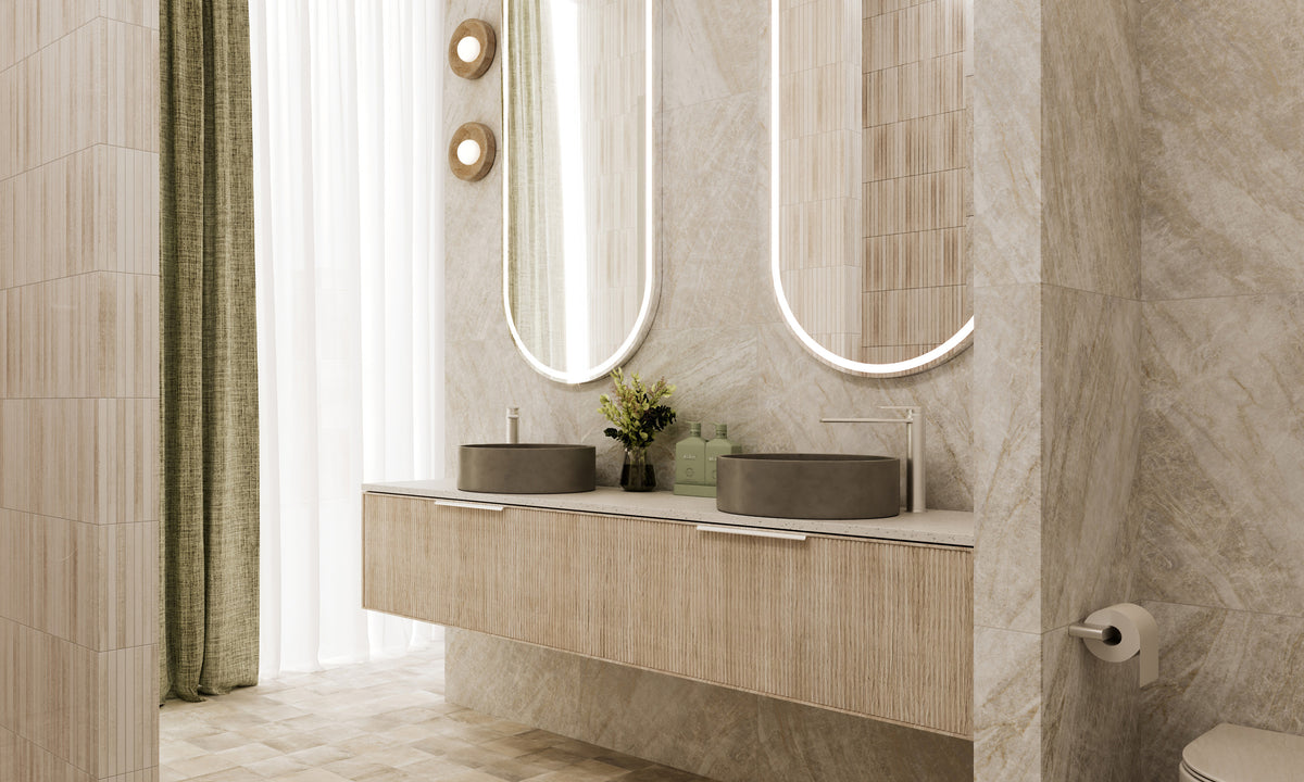 Oyster, Beaumont Tiles’ Tile of the Year, showcased in a luxurious bathroom featuring soft stone-look surfaces, textured feature tiles, floating timber cabinetry and illuminated arched mirrors.