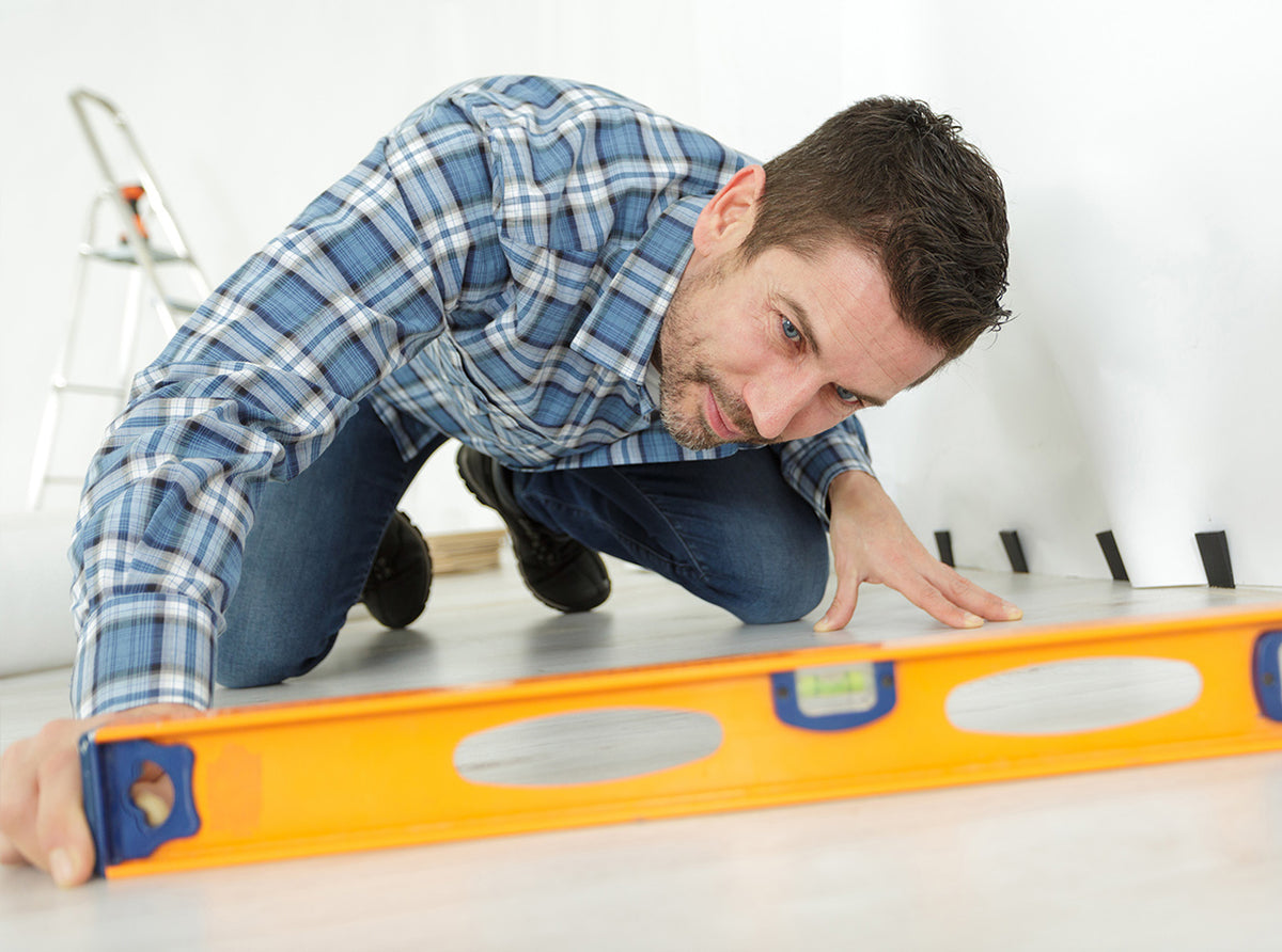 Checking a floor with a spirit level