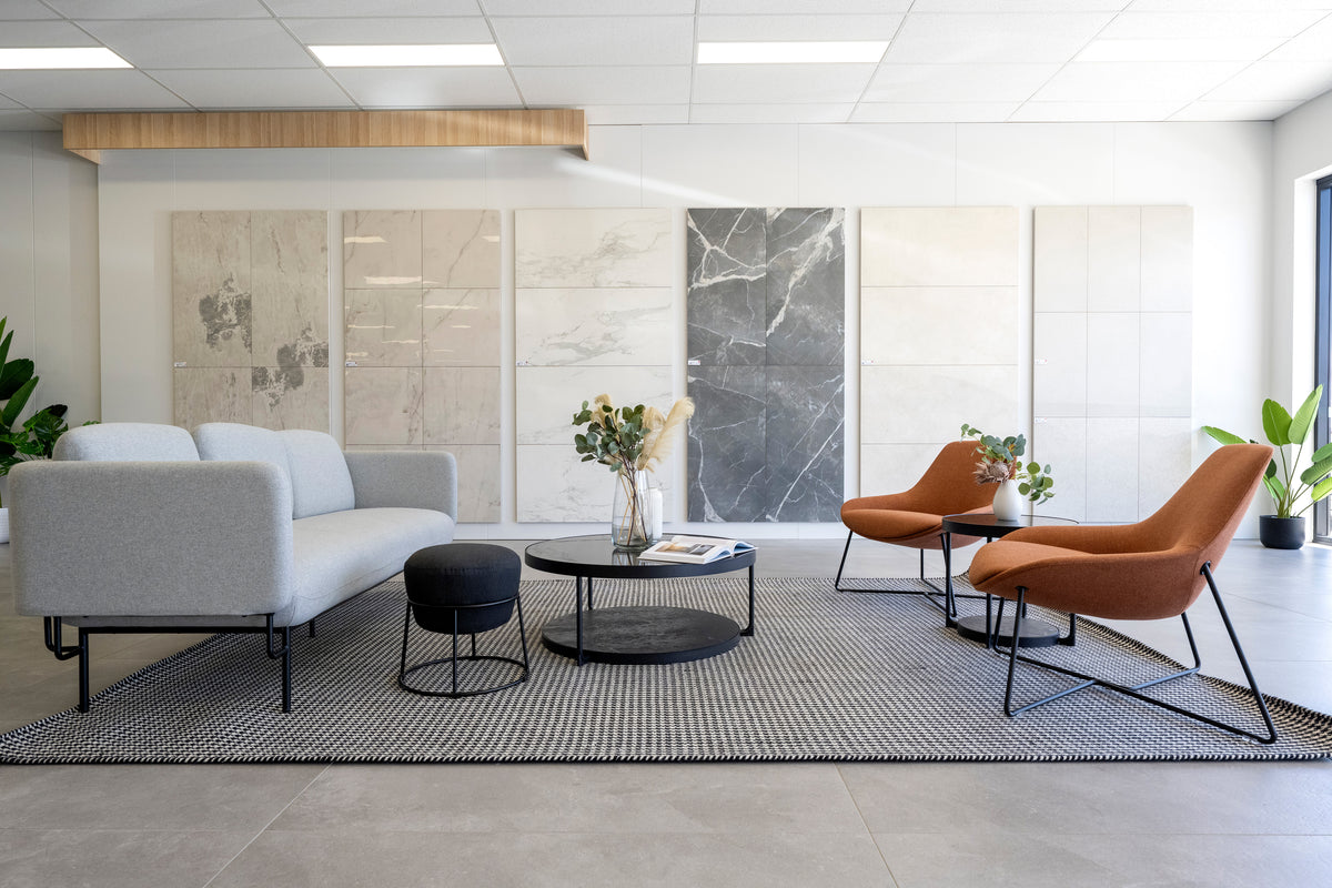Modern Beaumont Tiles showroom lounge featuring large-format tile displays, contemporary seating and design inspiration areas for customers planning renovation projects.