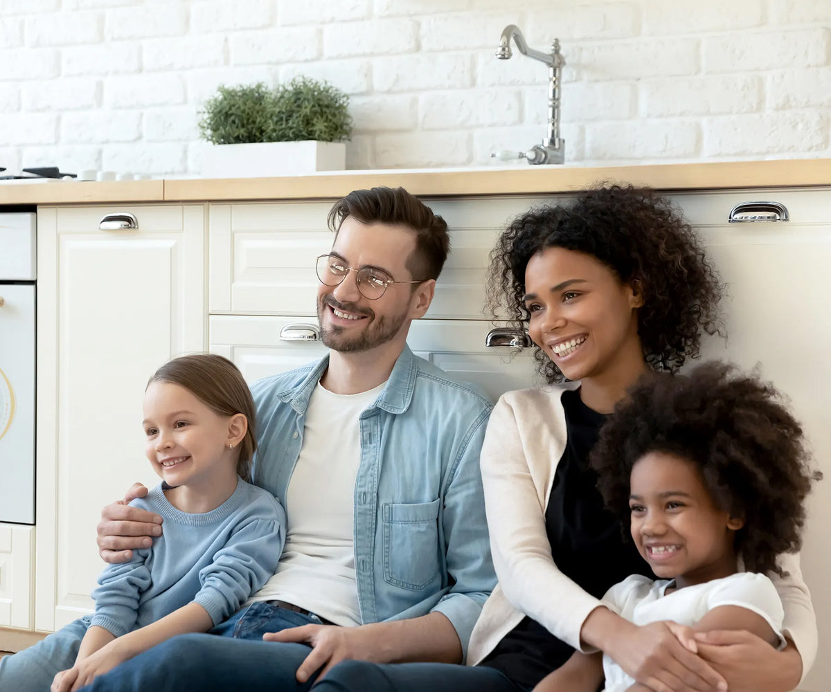 Family sitting in a kitchen