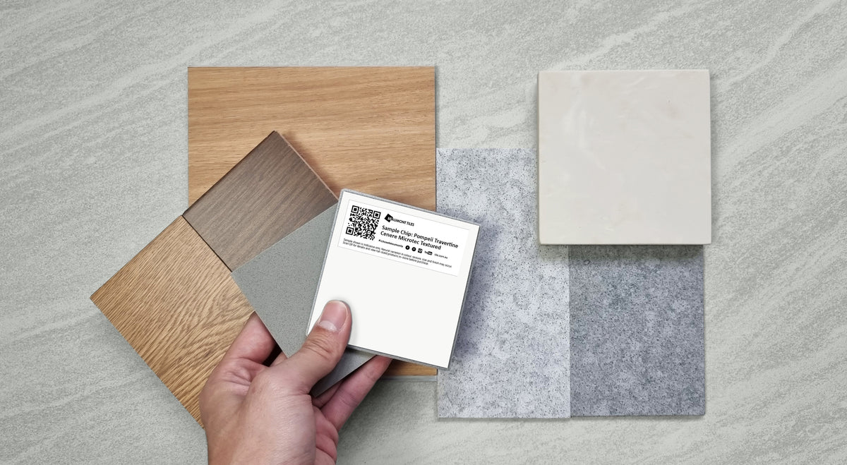 Hand holding a Beaumont Tiles sample tile alongside timber-look, stone-look and neutral colour samples to compare finishes and create a cohesive design palette.