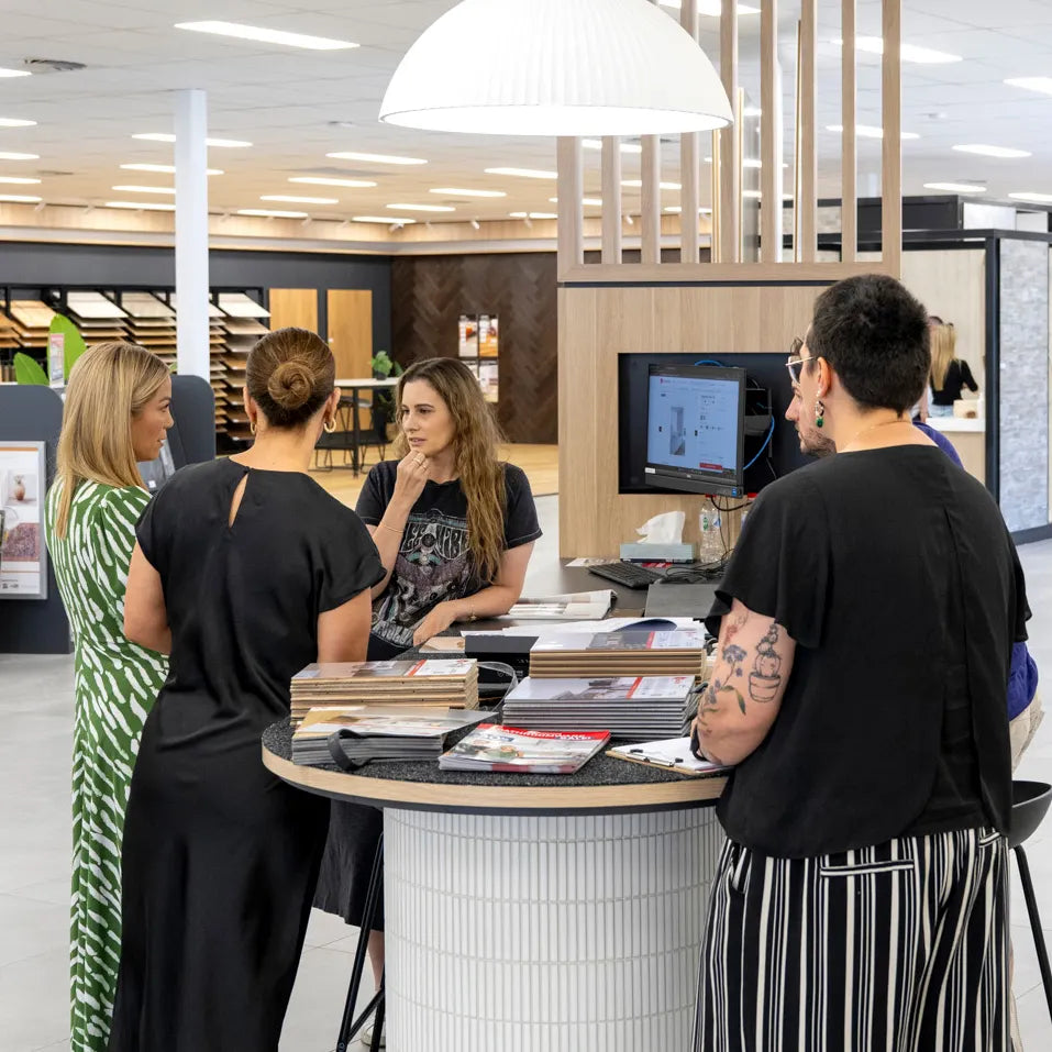 Beaumont Tiles design consultation with customers reviewing tile samples and flooring selections in a showroom.