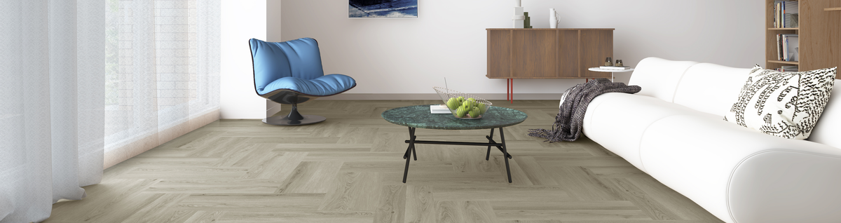 Modern living room featuring light timber-look herringbone flooring, white sofa and contemporary furniture.
